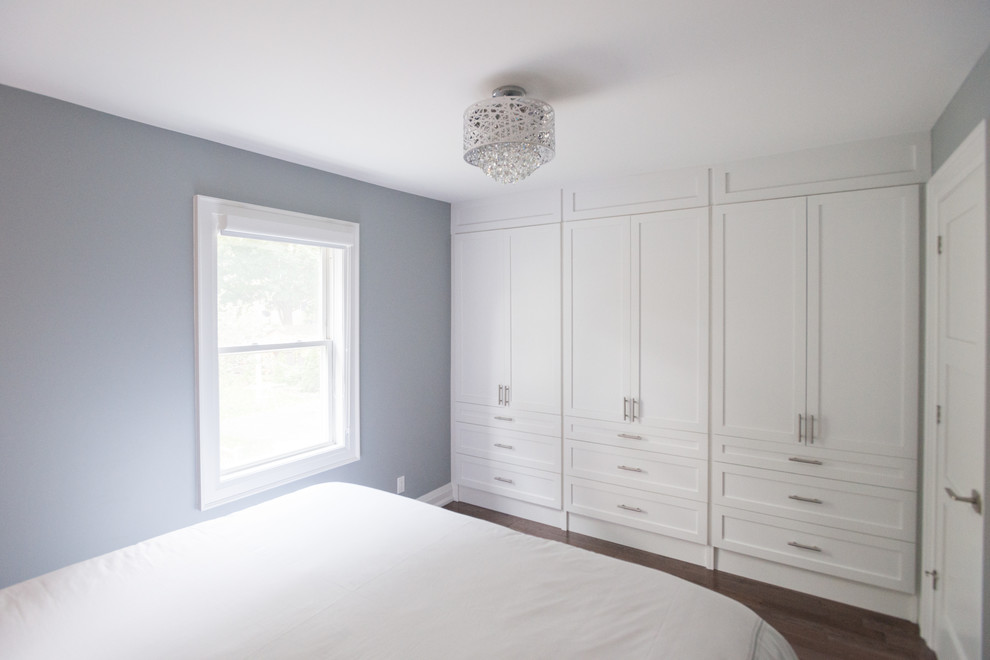 This is an example of a small contemporary master bedroom in Toronto with grey walls, medium hardwood flooring, no fireplace and brown floors.