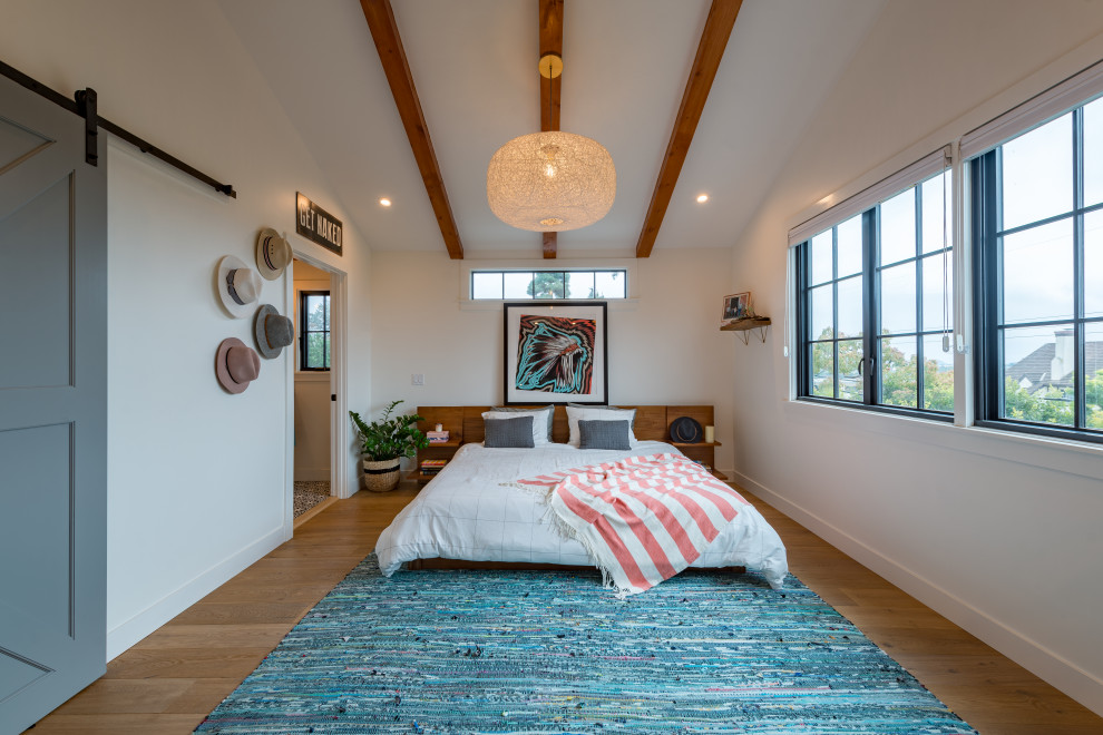 Inspiration for a large 1960s guest medium tone wood floor and beige floor bedroom remodel in Los Angeles with yellow walls