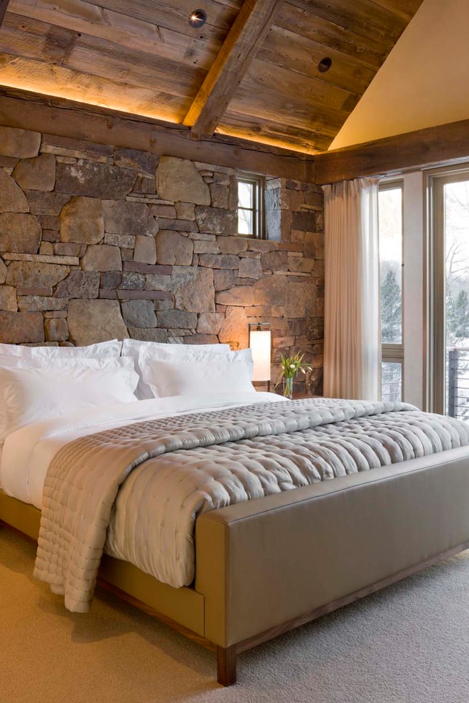 Example of a mountain style carpeted bedroom design in Denver with no fireplace