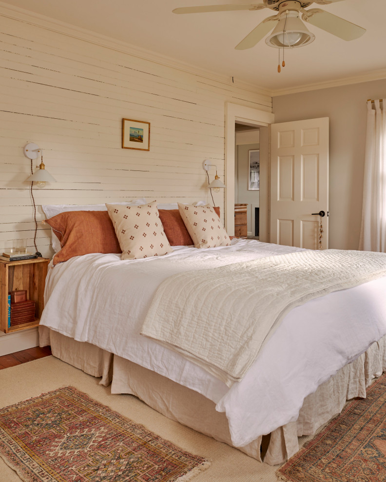 Landhaus Schlafzimmer mit grauer Wandfarbe, braunem Holzboden, braunem Boden und Holzdielenwänden in Bridgeport
