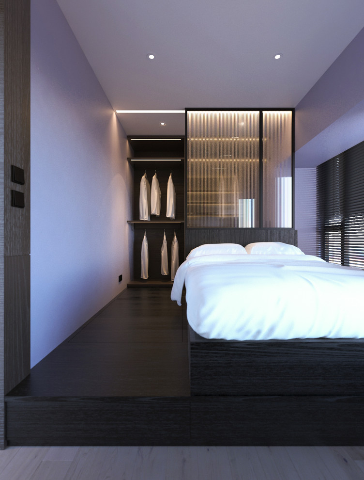 This is an example of a small modern mezzanine bedroom in Hong Kong with grey walls and light hardwood flooring.