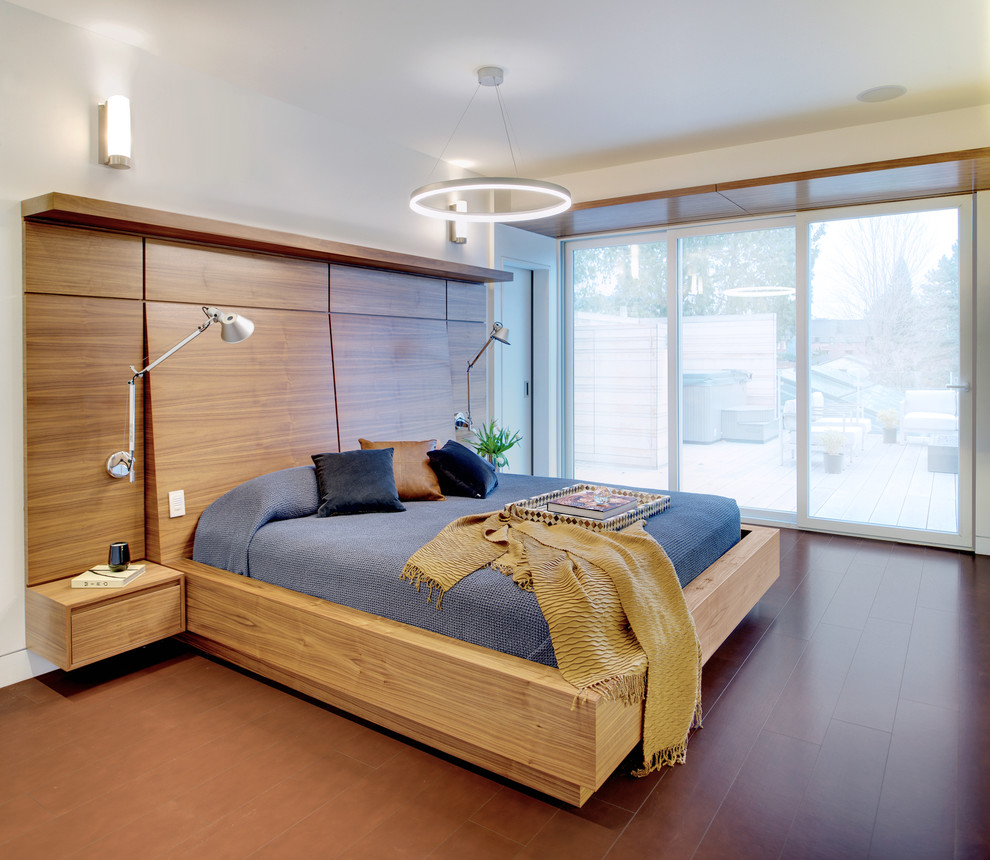 Ejemplo de dormitorio principal escandinavo de tamaño medio sin chimenea con paredes blancas y suelo marrón