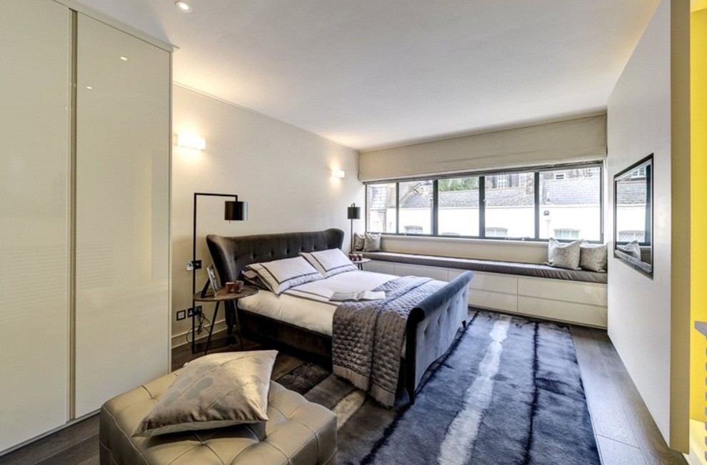 ロンドンにある広いコンテンポラリースタイルのおしゃれな主寝室 (グレーの壁、濃色無垢フローリング、茶色い床、グレーとブラウン)