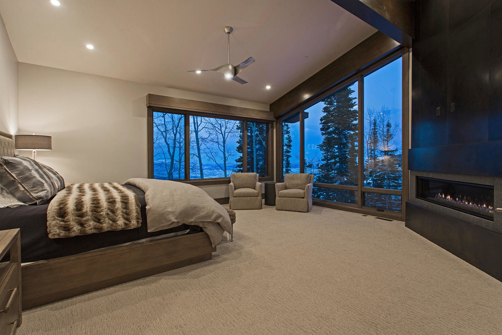 Bedroom - huge contemporary master carpeted, beige floor and exposed beam bedroom idea in Salt Lake City with gray walls, a corner fireplace and a metal fireplace