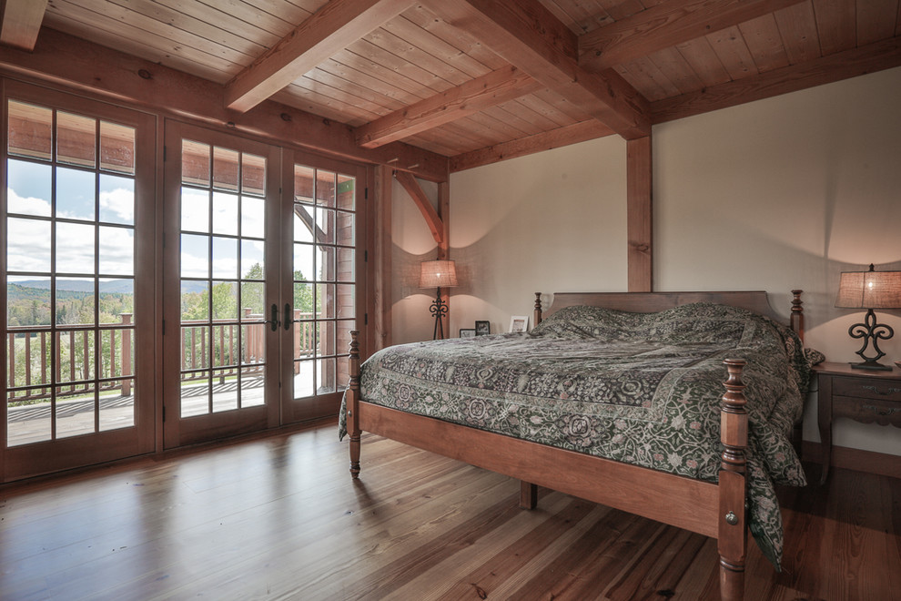 Example of a classic master medium tone wood floor bedroom design in Boston with beige walls