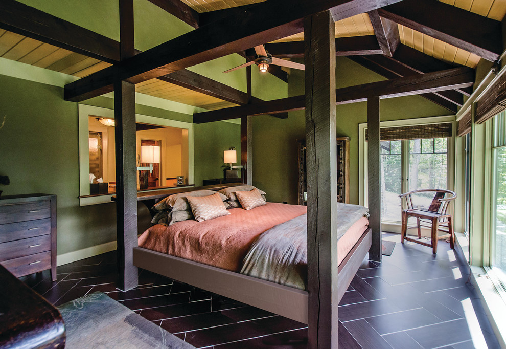 На фото: огромная хозяйская спальня в стиле кантри с зелеными стенами, полом из керамической плитки и черным полом без камина с