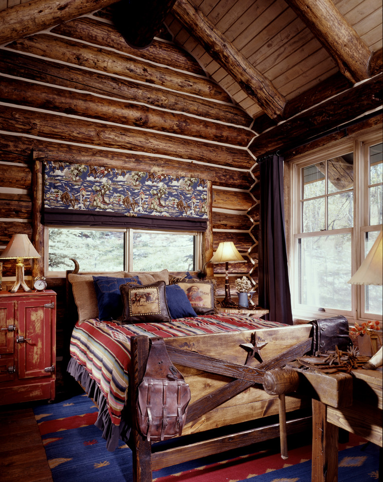 Rustic bedroom in Denver with dark hardwood flooring.