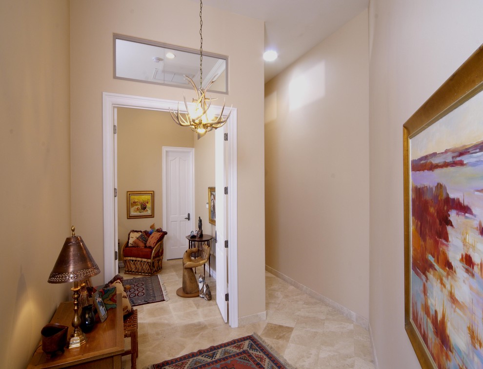 Example of a large eclectic master porcelain tile bedroom design in Phoenix with beige walls