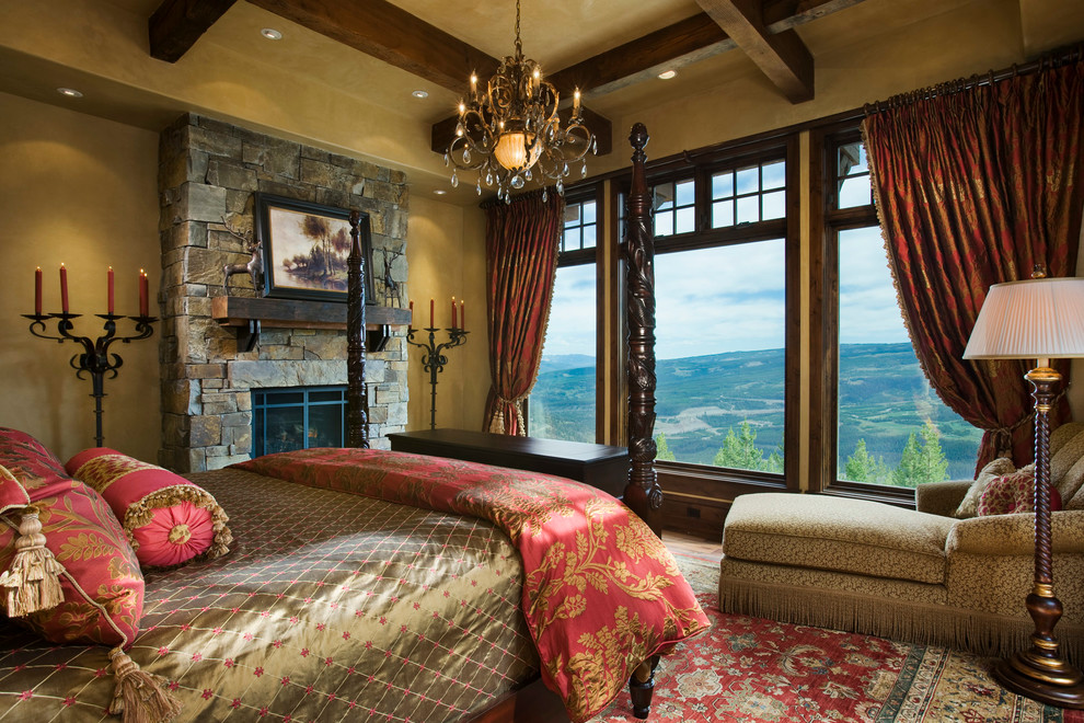 Design ideas for a rustic bedroom in Other with beige walls, a standard fireplace and a stone fireplace surround.