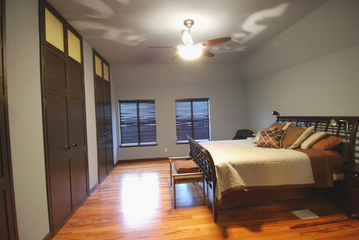 Large trendy master bamboo floor bedroom photo in Austin with gray walls and no fireplace