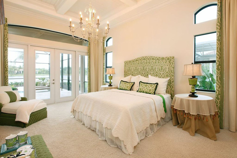 Large traditional master bedroom in Miami with white walls and carpet.