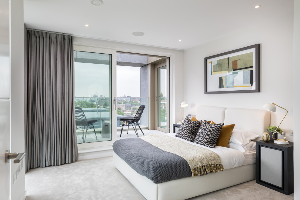 Photo of a contemporary bedroom in Surrey with white walls, carpet and grey floors.