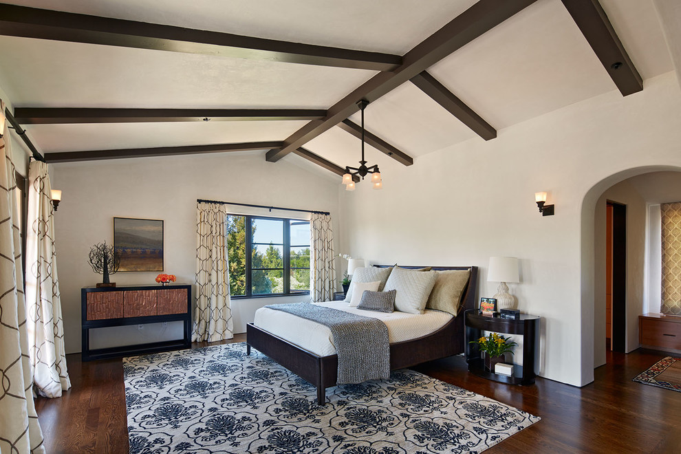Mediterranean master bedroom in San Francisco with white walls, dark hardwood flooring and no fireplace.