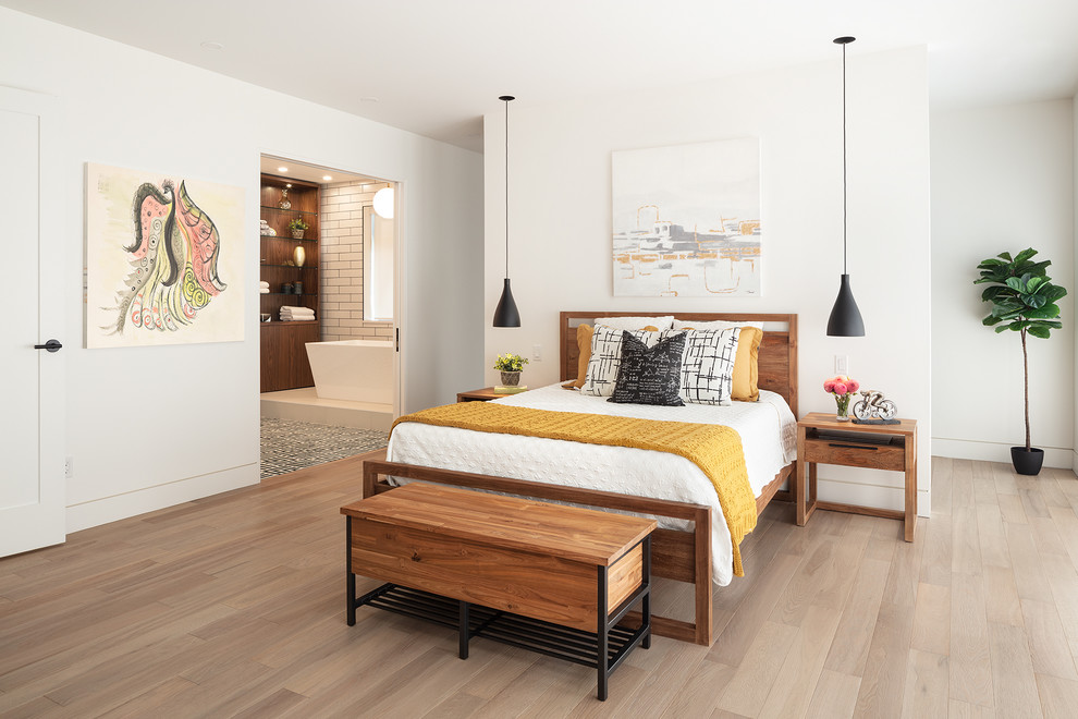Design ideas for a contemporary master bedroom in Vancouver with white walls and light hardwood flooring.