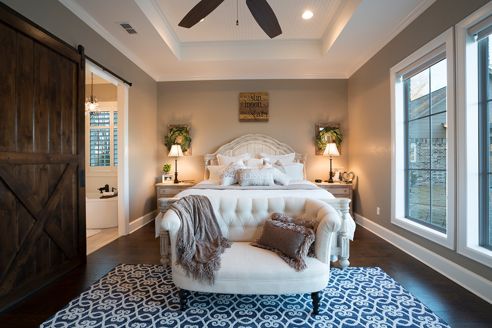 Photo of a large traditional master bedroom in Austin with grey walls, dark hardwood flooring and brown floors.