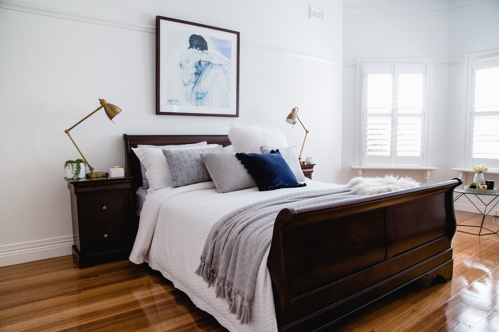 Foto de dormitorio principal escandinavo grande con paredes blancas y suelo de madera en tonos medios