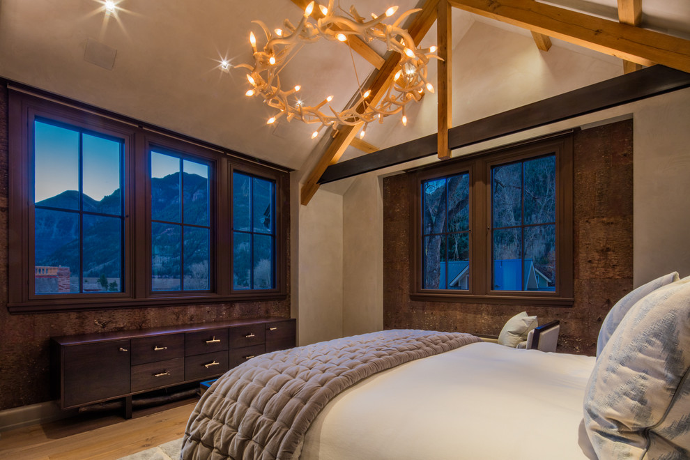 Rustic master bedroom in Denver with beige walls and light hardwood flooring.