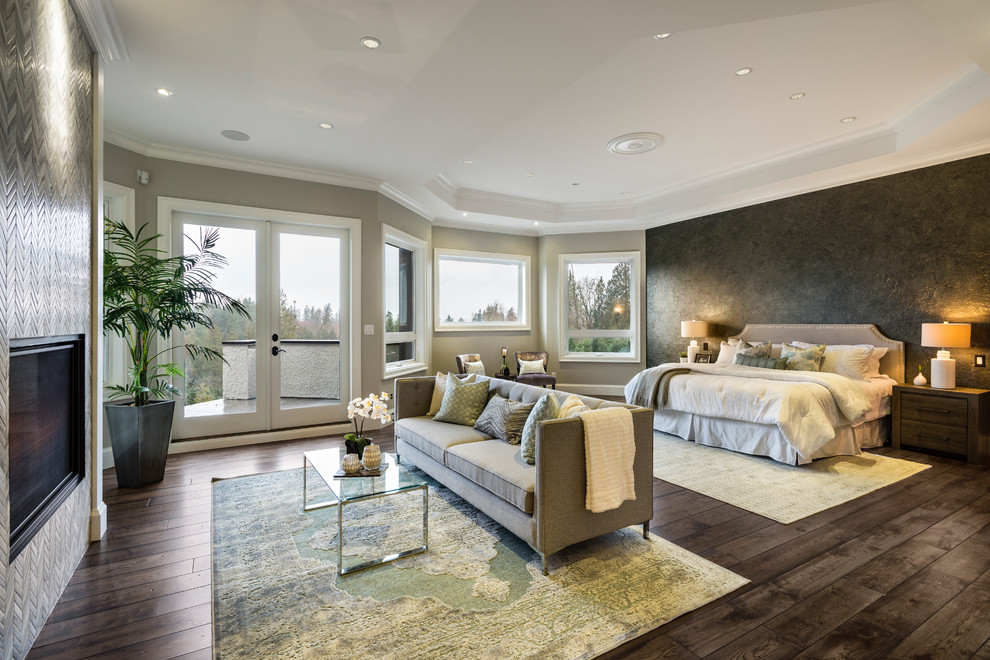 Inspiration for a huge transitional master medium tone wood floor and brown floor bedroom remodel in Vancouver with multicolored walls, a standard fireplace and a tile fireplace