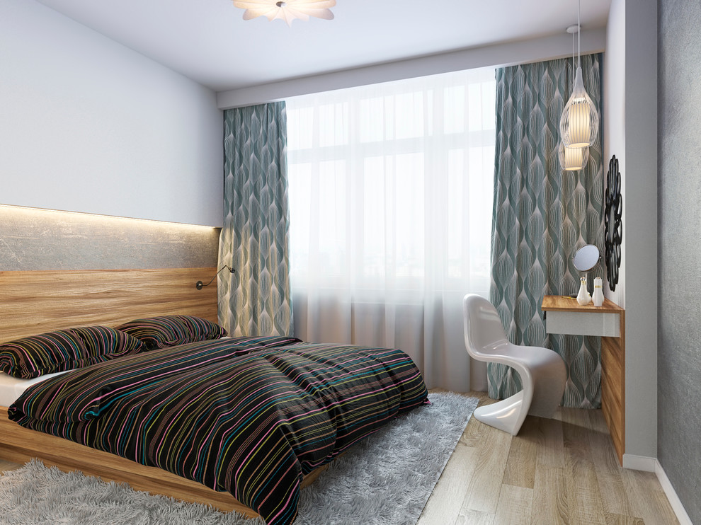 Imagen de dormitorio actual con paredes grises y suelo de madera clara
