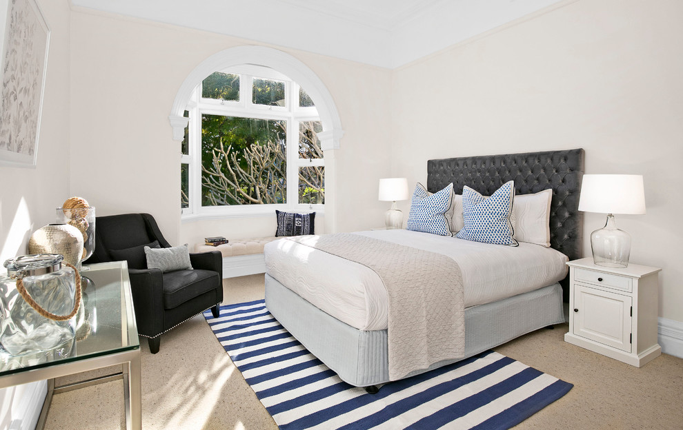 Example of a large transitional master carpeted bedroom design in Sydney with beige walls