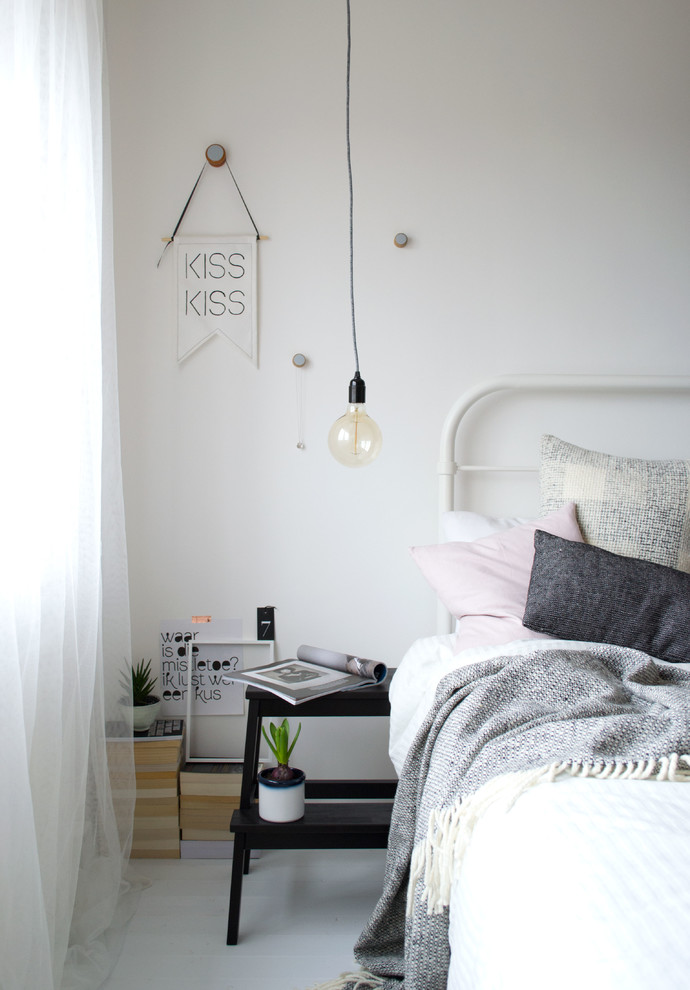 Inspiration for a mid-sized scandinavian master painted wood floor bedroom remodel in Kent with white walls and no fireplace