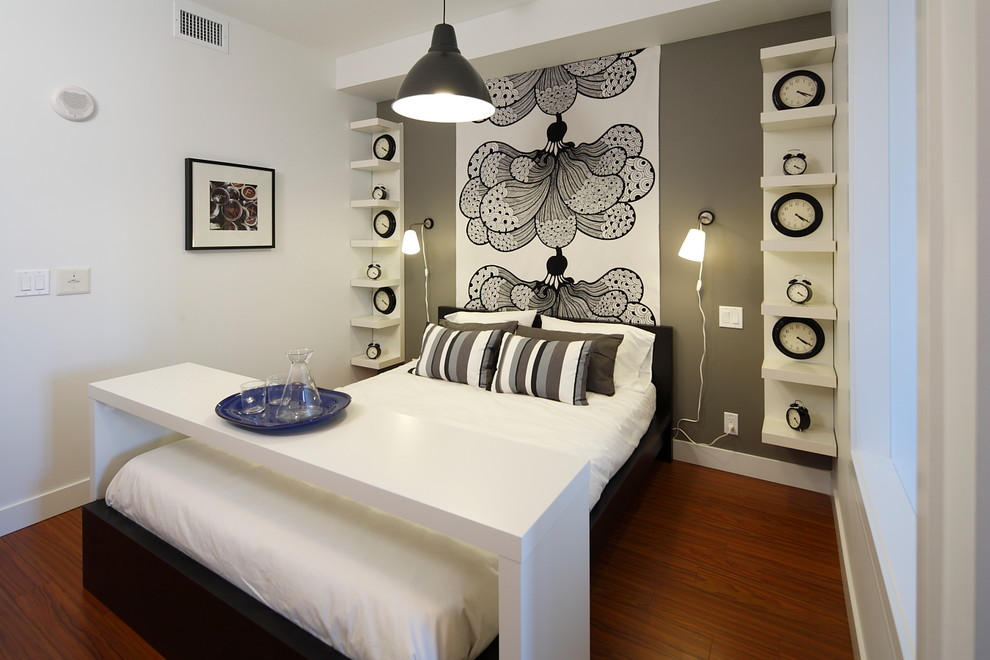 Inspiration for a contemporary grey and cream bedroom in Calgary with white walls and medium hardwood flooring.