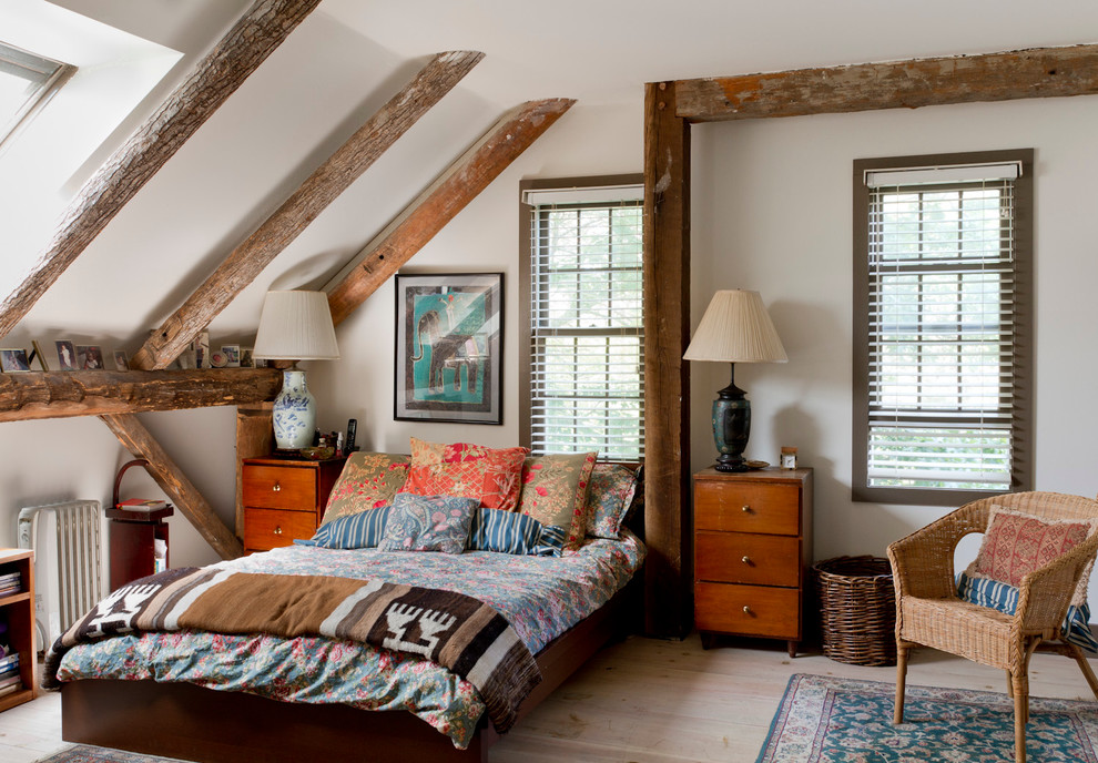 Example of an eclectic master light wood floor bedroom design in New York with white walls