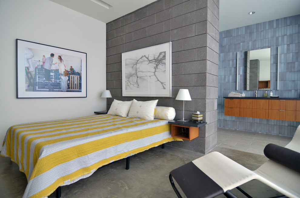 Modelo de dormitorio retro con paredes blancas y suelo de cemento