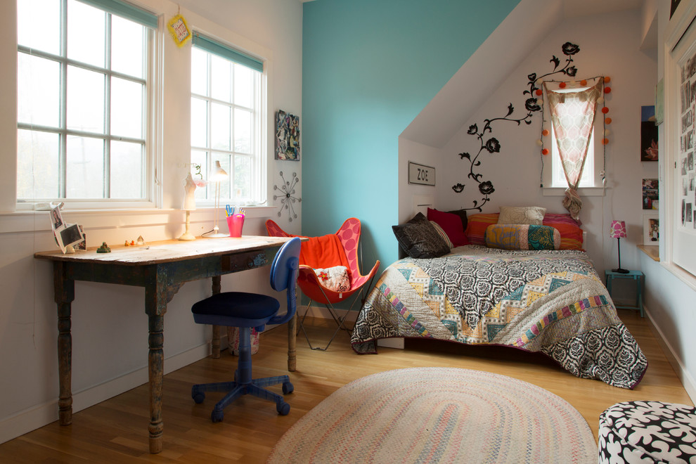 Immagine di una camera da letto bohémian con pareti bianche e pavimento in legno massello medio