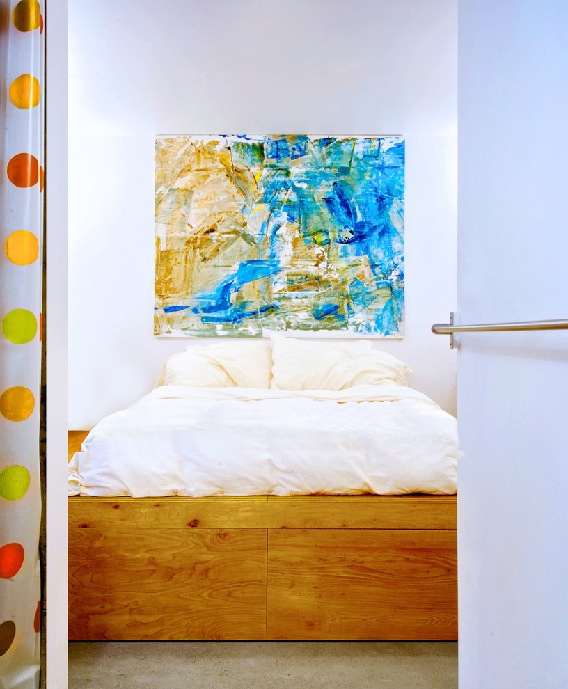 Trendy concrete floor bedroom photo in Toronto with white walls