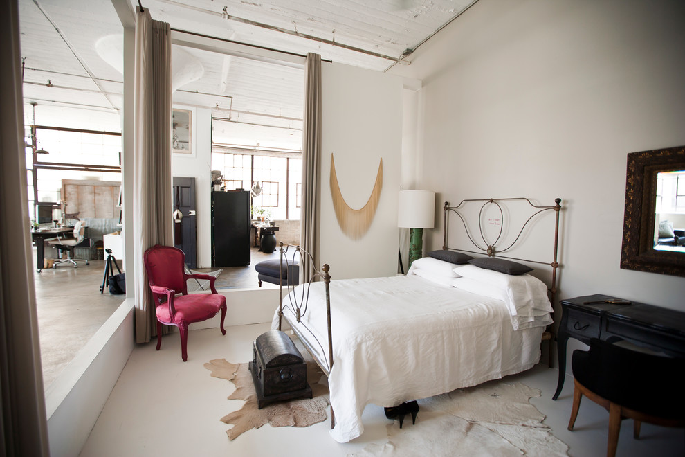 Urban bedroom in New York with concrete flooring.