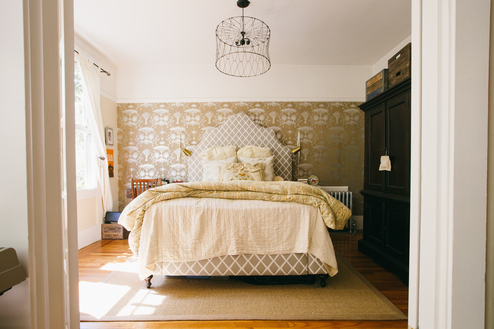 Ispirazione per una camera da letto boho chic con pareti beige e pavimento in legno massello medio