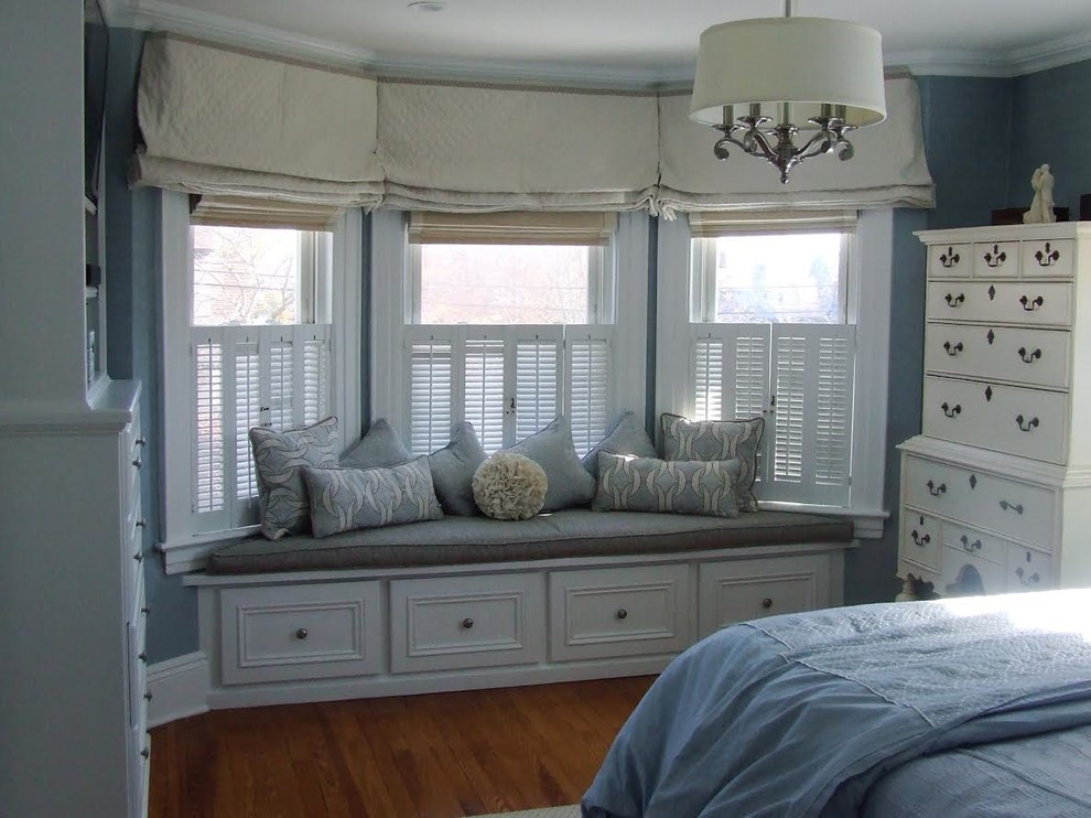 Bedroom - transitional master medium tone wood floor bedroom idea in New York with blue walls