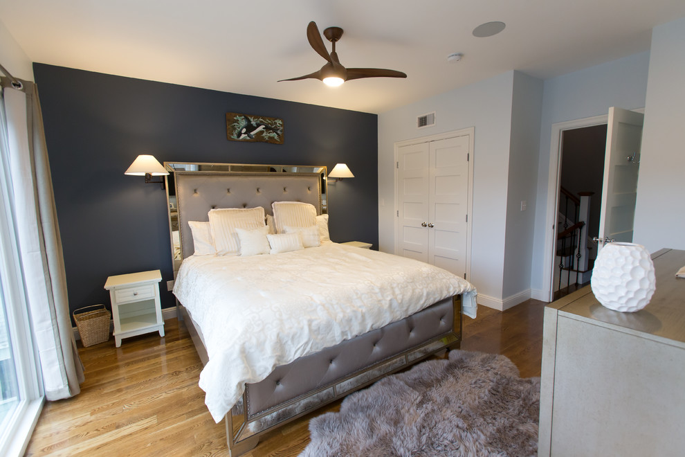 Mid-sized transitional master medium tone wood floor bedroom photo in Boston with gray walls and no fireplace