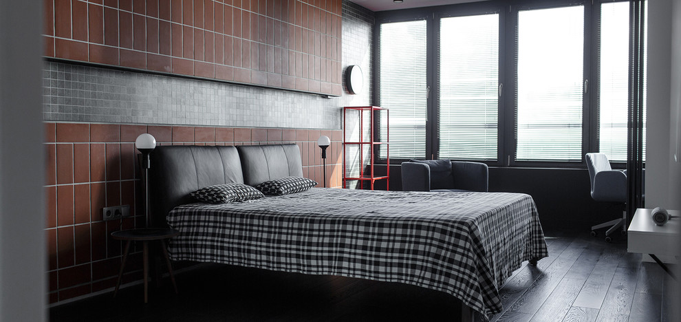 Foto di una camera da letto industriale di medie dimensioni con pareti grigie, pavimento in gres porcellanato e pavimento nero