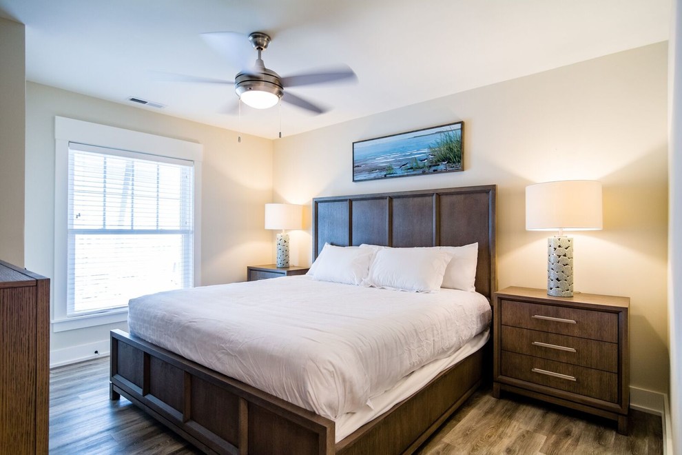 Bedroom - small coastal guest vinyl floor and brown floor bedroom idea in Other with beige walls and no fireplace