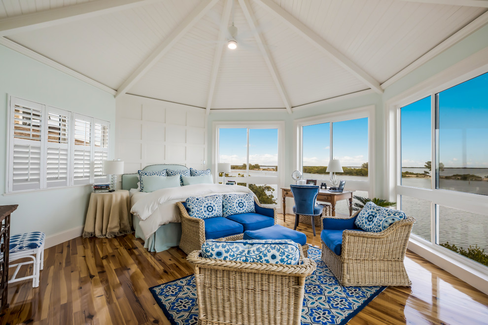 Foto di una camera da letto costiera con pareti blu, parquet scuro e pavimento marrone