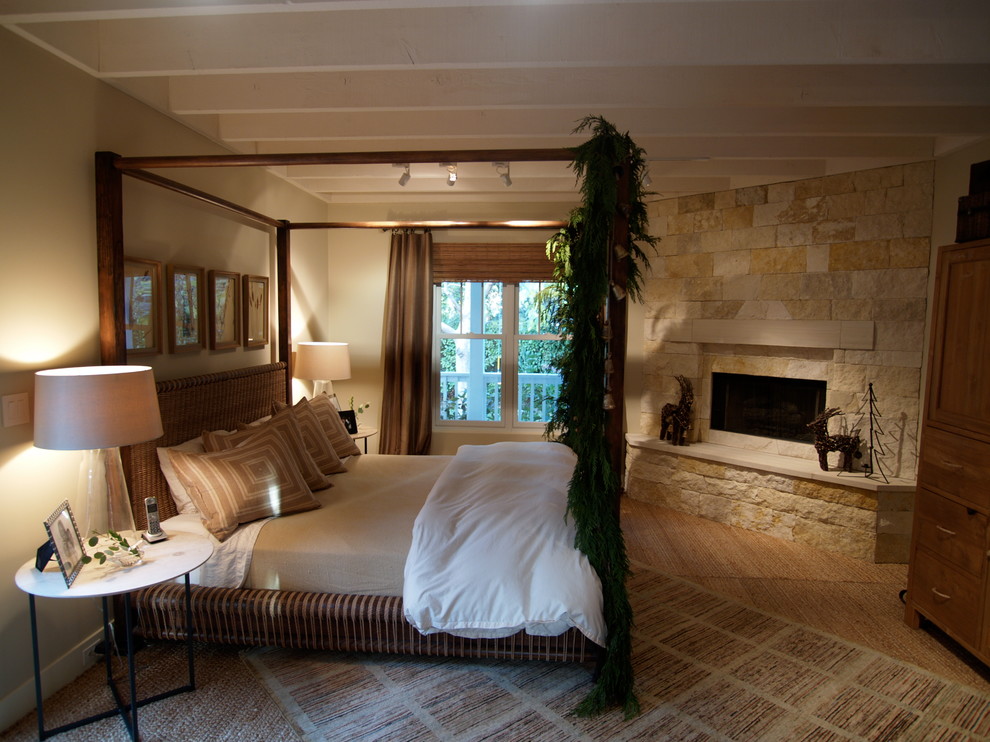 Example of a large country master brown floor and carpeted bedroom design in San Francisco with a corner fireplace, a stone fireplace and beige walls