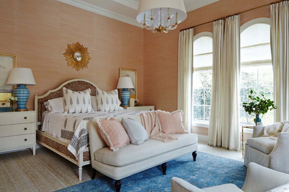 Design ideas for an expansive traditional master bedroom in Miami with pink walls and carpet.