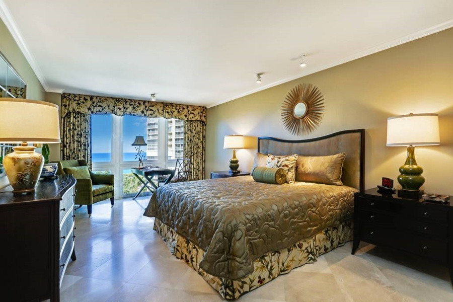 Large trendy master travertine floor bedroom photo in Jacksonville with beige walls