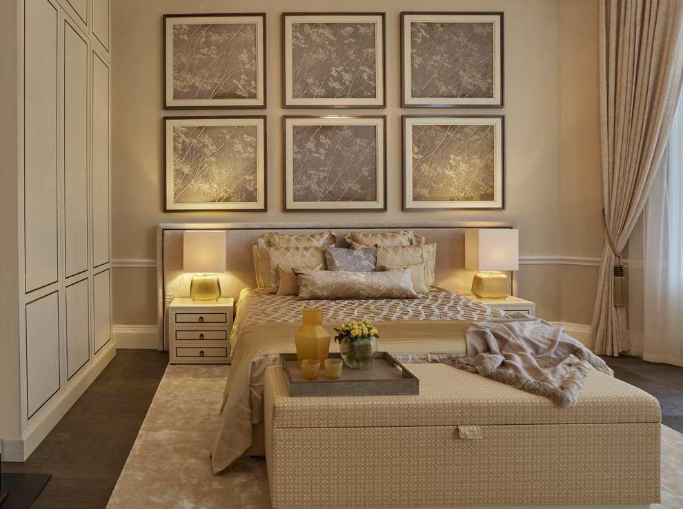 Example of a large ornate master dark wood floor bedroom design in London with beige walls