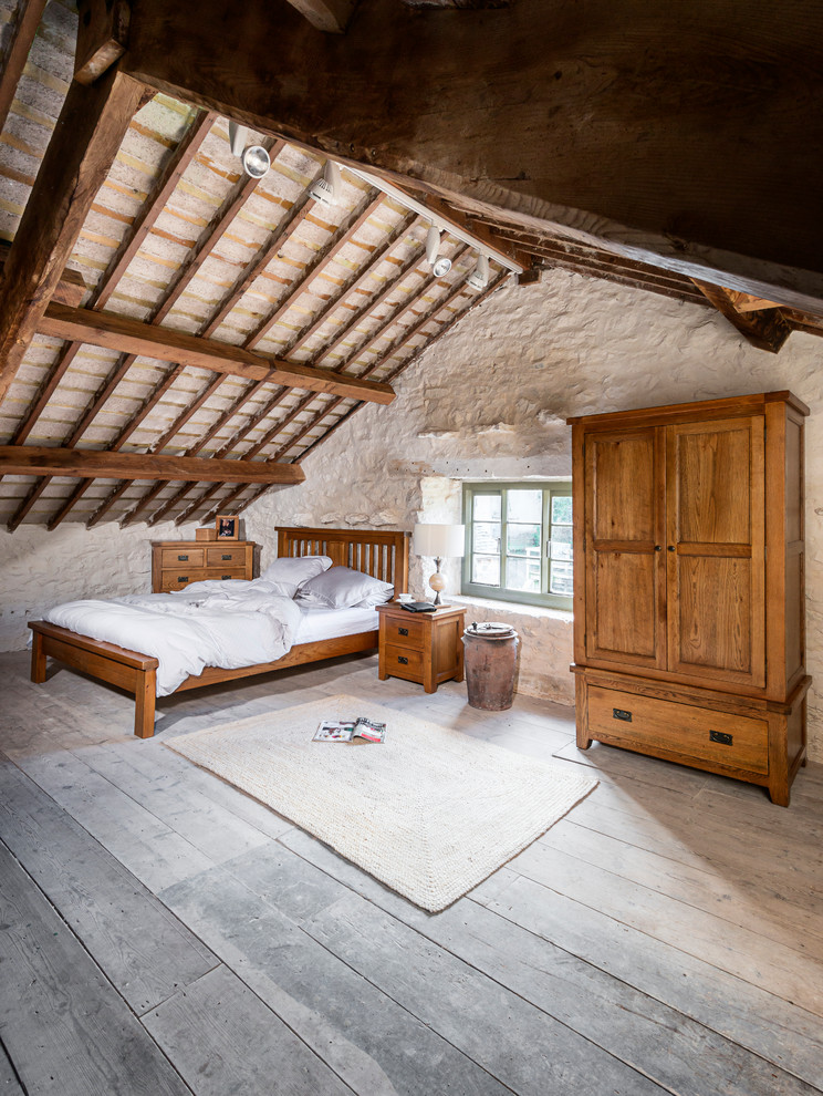 This is an example of a medium sized rustic bedroom in Other with white walls, light hardwood flooring and no fireplace.