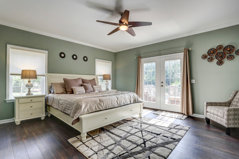 Classic master and grey and brown bedroom in Other with green walls, dark hardwood flooring and brown floors.