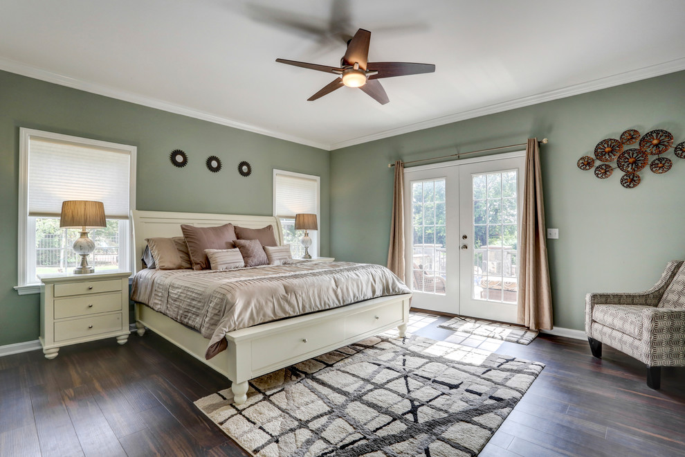 Example of a classic master dark wood floor and brown floor bedroom design in Other with green walls