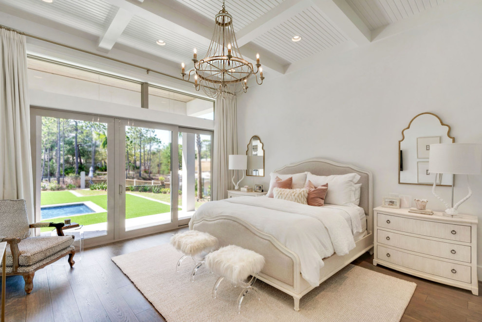 Design ideas for a large beach style master bedroom with white walls, medium hardwood flooring and no fireplace.