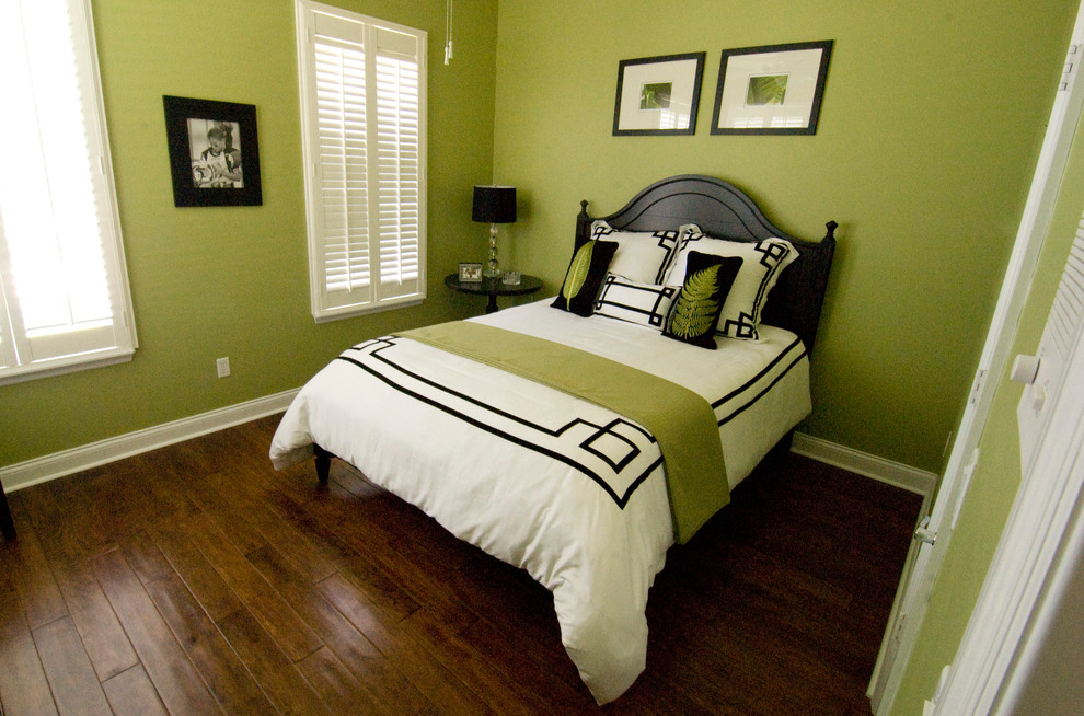 Foto di una camera degli ospiti contemporanea con pareti verdi, pavimento in legno massello medio e nessun camino