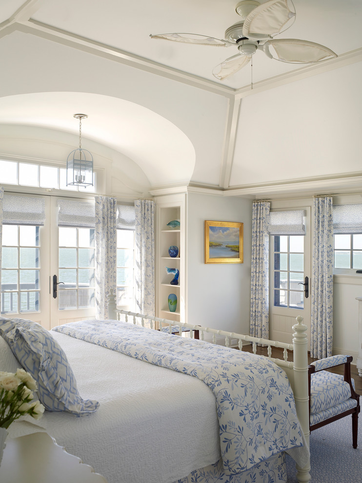 Design ideas for a coastal bedroom in New York with white walls.