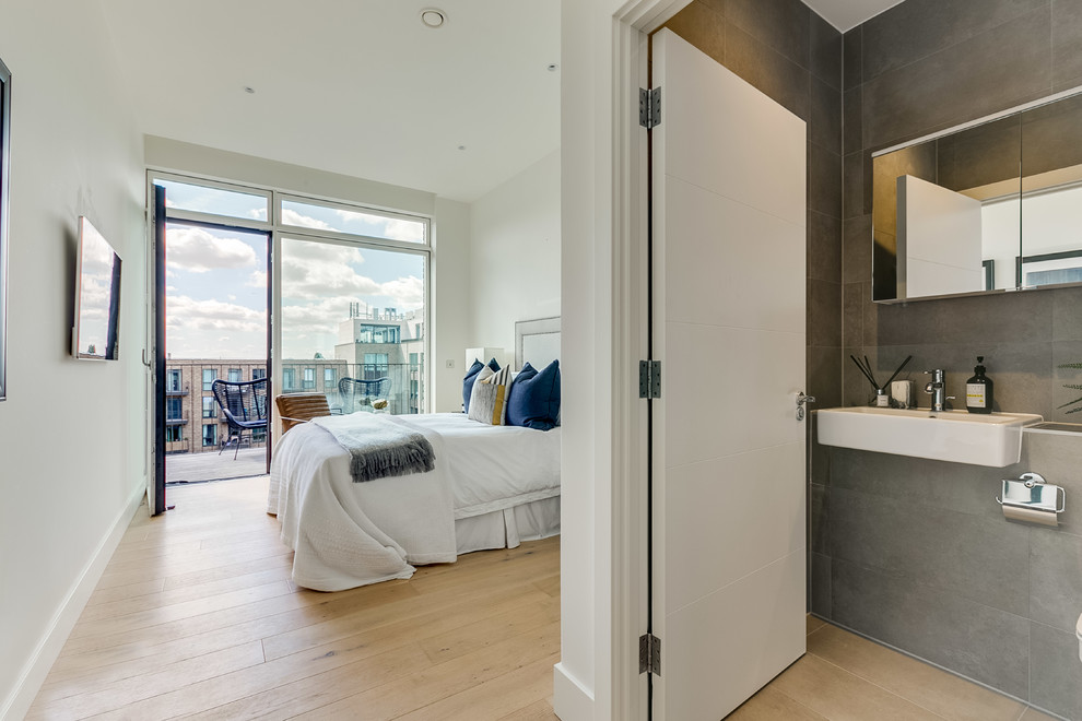 Bedroom - mid-sized contemporary master light wood floor and beige floor bedroom idea in London with white walls