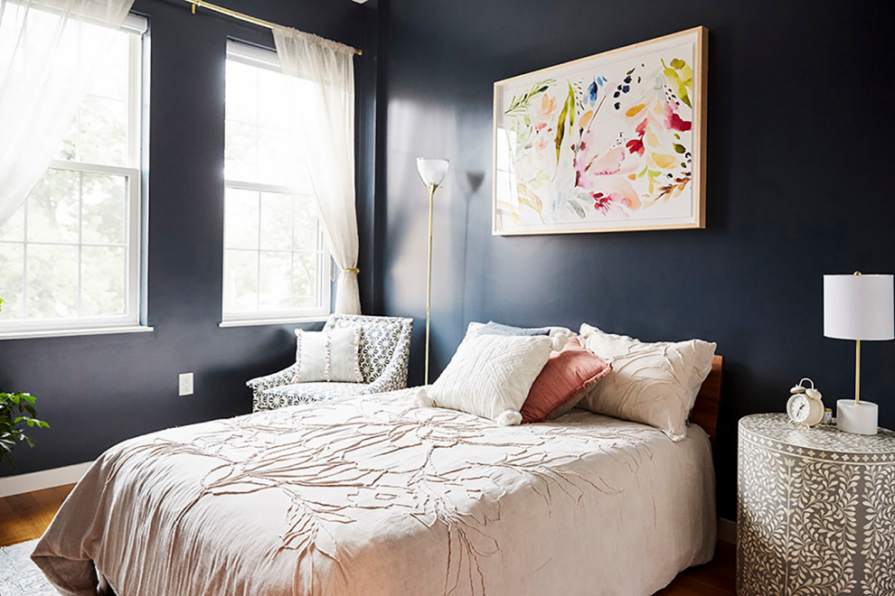 Inspiration for a mid-sized modern guest medium tone wood floor and brown floor bedroom remodel in New York with blue walls