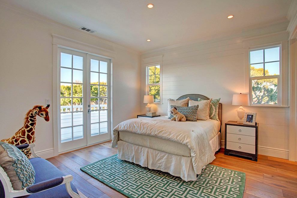 Nautical bedroom in Los Angeles with white walls and medium hardwood flooring.